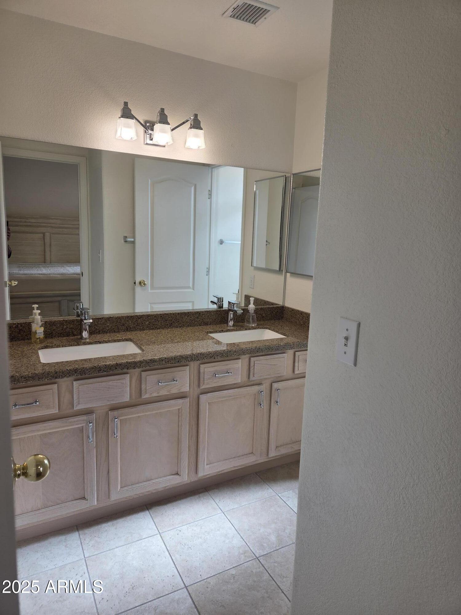 9151 West Greenway Road, Unit 182 Peoria, AZ 85381 - Photo 7 of 19 a bathroom with a sink and a mirror