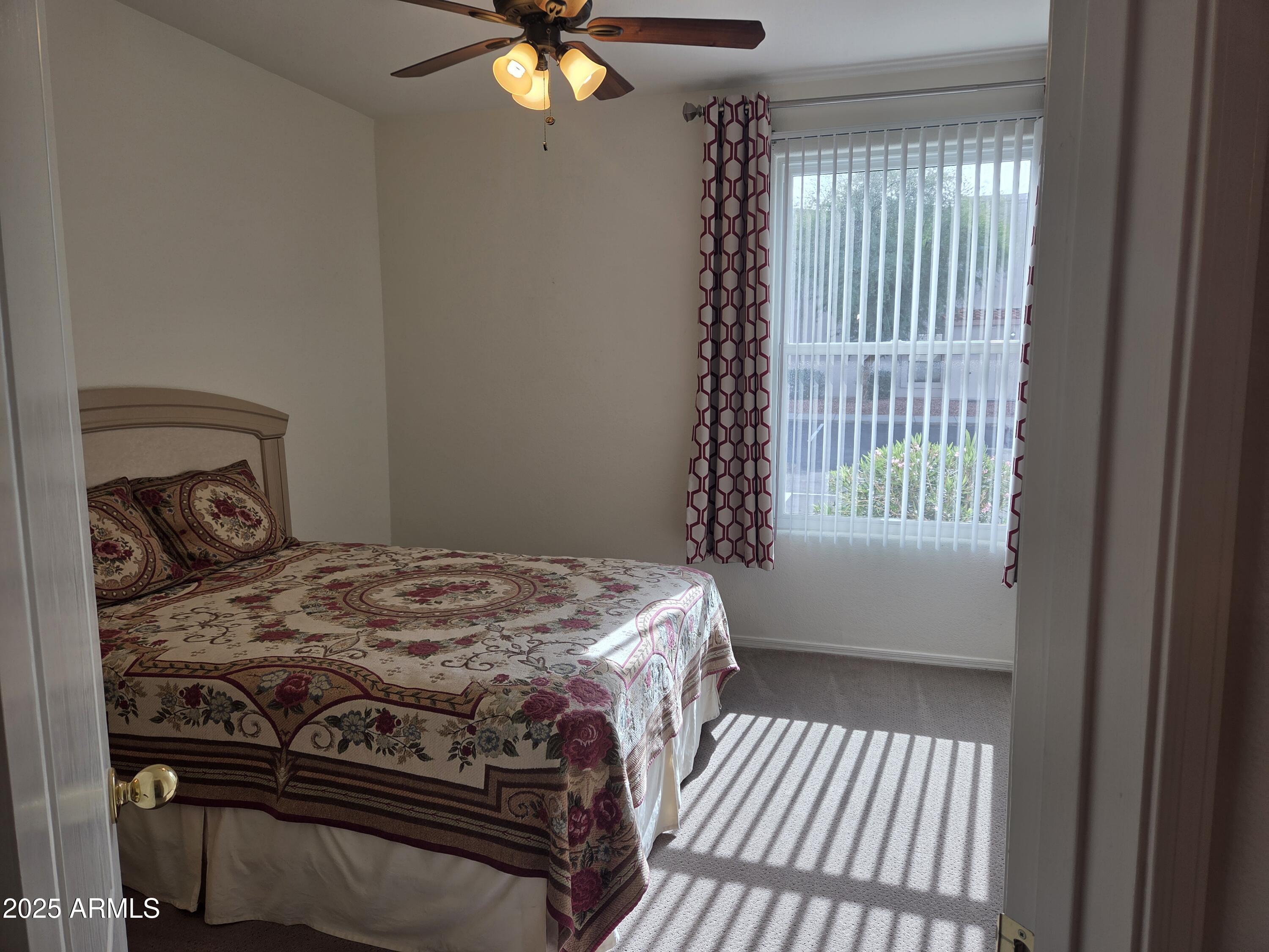 9151 West Greenway Road, Unit 182 Peoria, AZ 85381 - Photo 9 of 19 a bedroom with a bed and a window