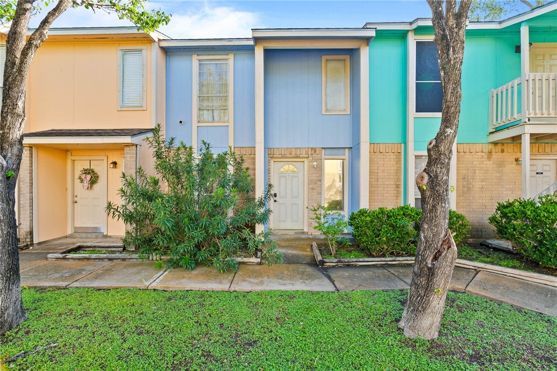 6702 Everhart Road, Unit H102 Corpus Christi, TX 78413 - Photo 1 of 15 a front view of a house with a yard