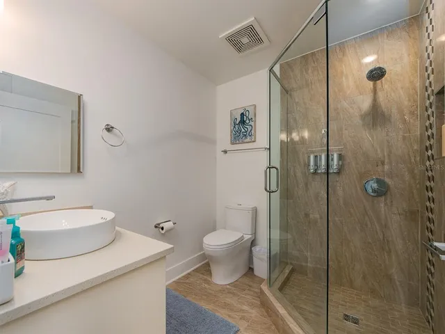 a bathroom with a sink a mirror and shower