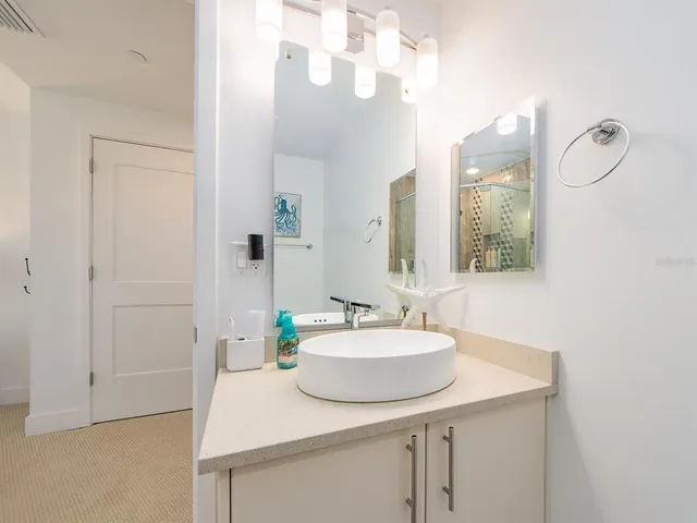 a bathroom with a sink and a shower curtain