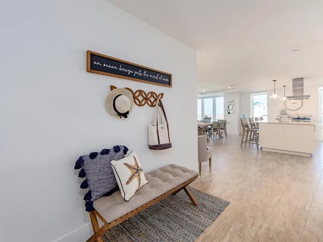 a living room with furniture a rug and wooden floor
