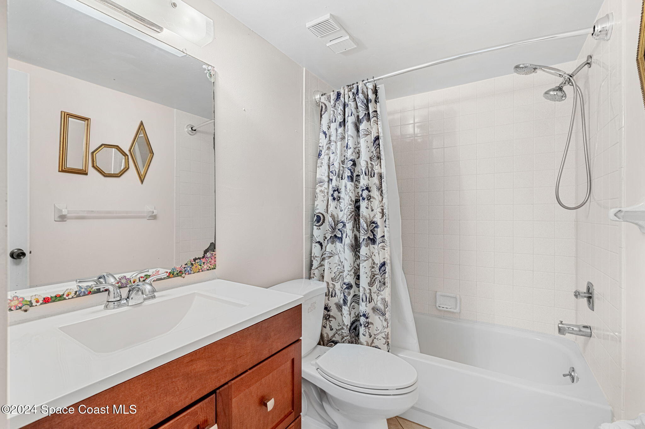 5807 North Atlantic Avenue, Unit 411 Cape Canaveral, FL 32920 - Photo 13 of 31 a bathroom with a sink toilet and shower