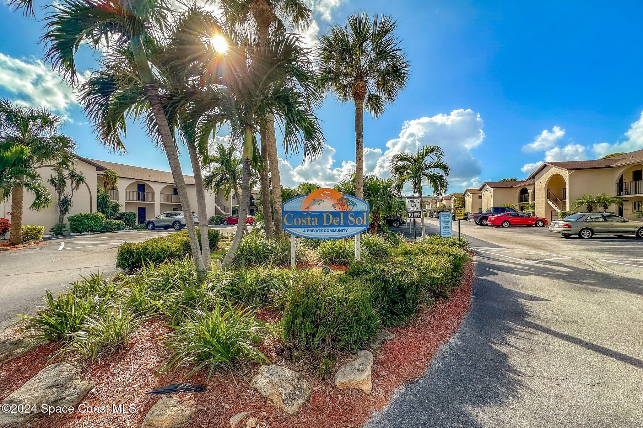 5807 North Atlantic Avenue, Unit 411 Cape Canaveral, FL 32920 - Photo 22 of 31 a view of street with parking and a cars parked