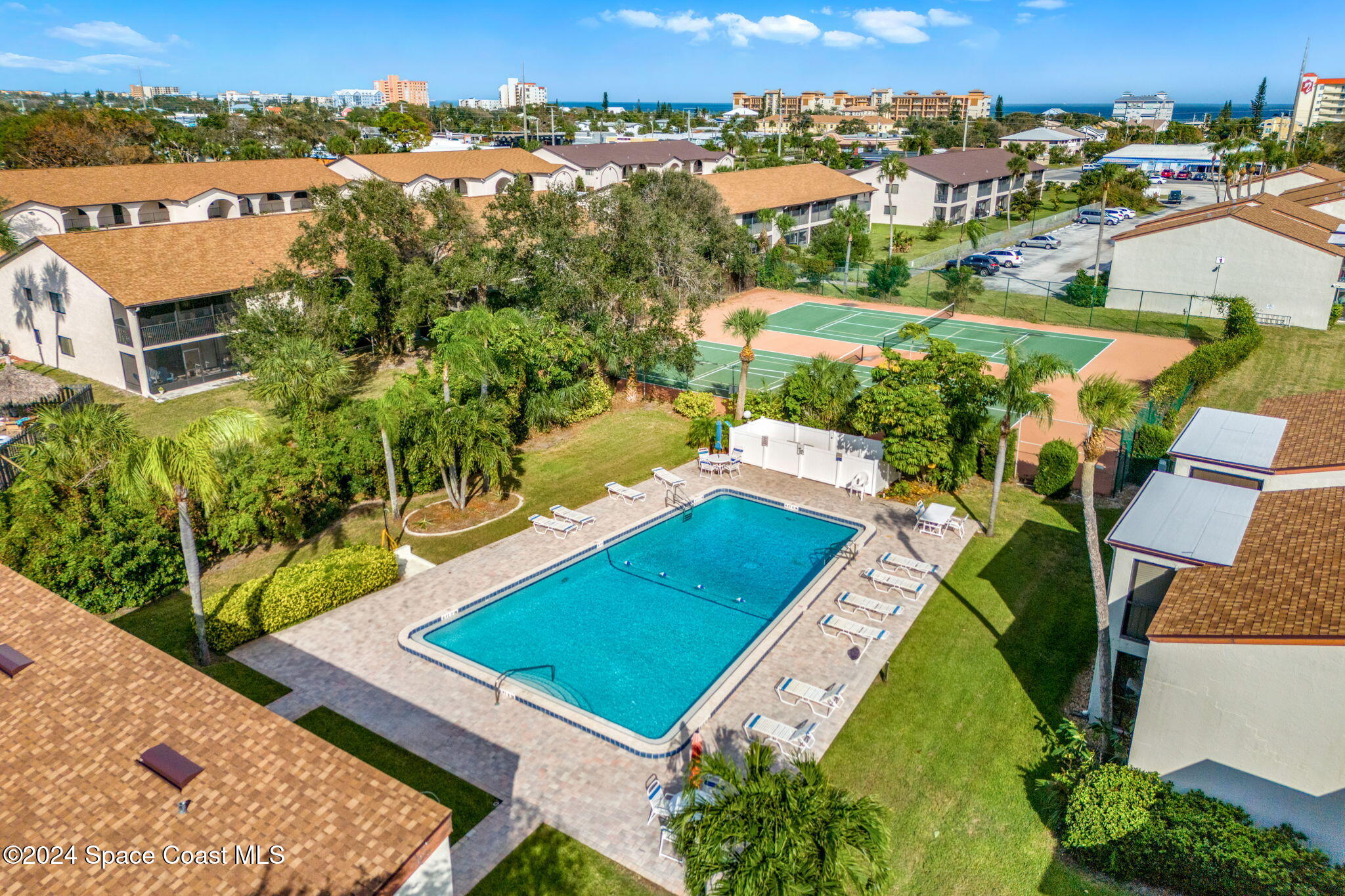 5807 North Atlantic Avenue, Unit 411 Cape Canaveral, FL 32920 - Photo 24 of 31 an aerial view of a house with a garden
