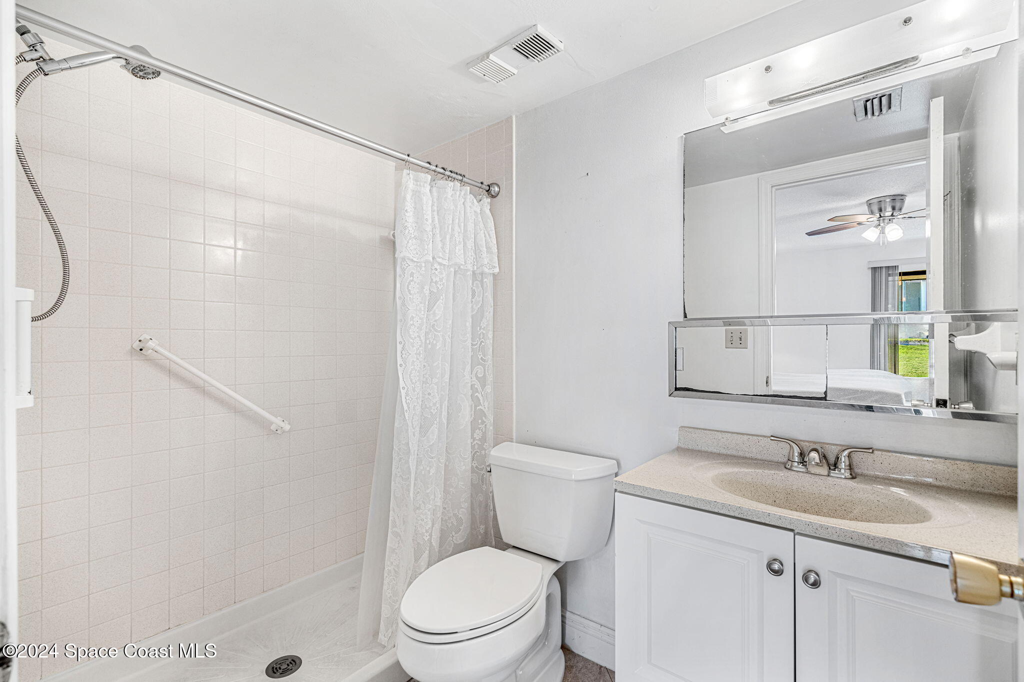 5807 North Atlantic Avenue, Unit 411 Cape Canaveral, FL 32920 - Photo 10 of 31 a bathroom with a sink a toilet and shower