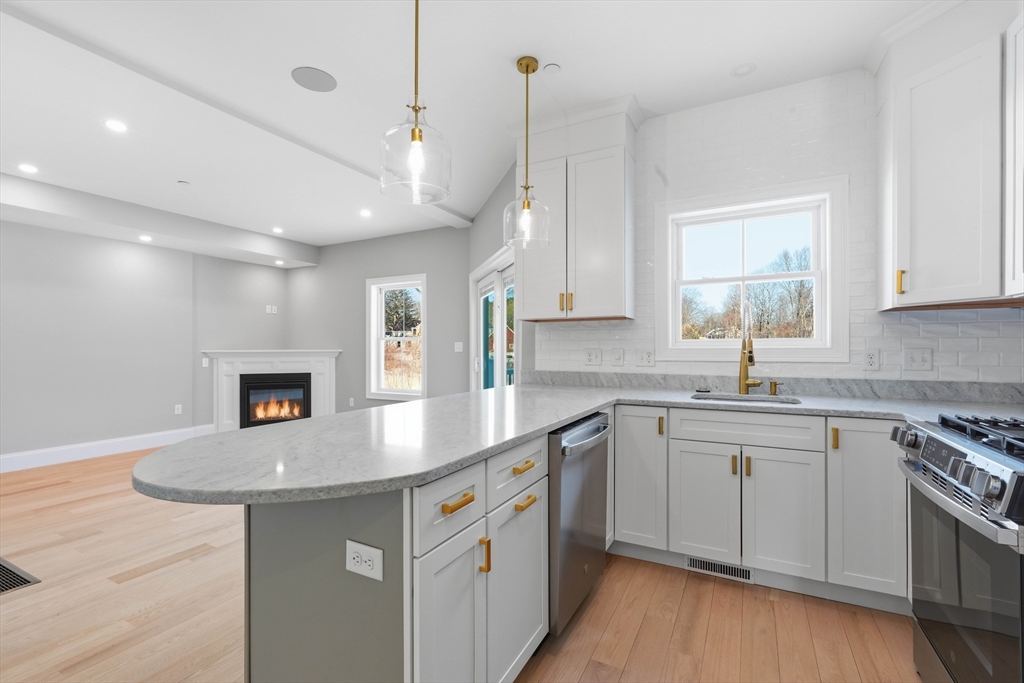 51 West Main Street, Unit 6R Georgetown, MA 01833 - Photo 11 of 40 a kitchen with stainless steel appliances granite countertop a sink stove and refrigerator