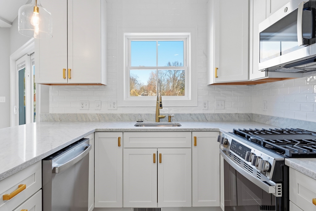 51 West Main Street, Unit 6R Georgetown, MA 01833 - Photo 12 of 40 a kitchen with white cabinets and appliances