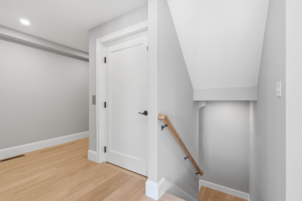 51 West Main Street, Unit 6R Georgetown, MA 01833 - Photo 18 of 40 a view of a hallway with wooden floor and staircase