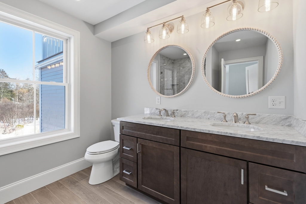 51 West Main Street, Unit 6R Georgetown, MA 01833 - Photo 22 of 40 a bathroom with a toilet sink and mirror
