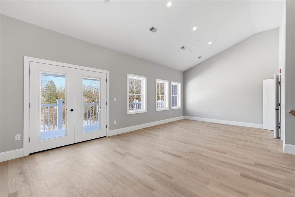 51 West Main Street, Unit 6R Georgetown, MA 01833 - Photo 33 of 40 a view of an empty room with a window and wooden floor