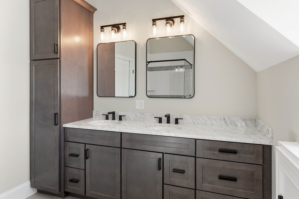 51 West Main Street, Unit 6R Georgetown, MA 01833 - Photo 37 of 40 a bathroom with a double vanity sink and mirror