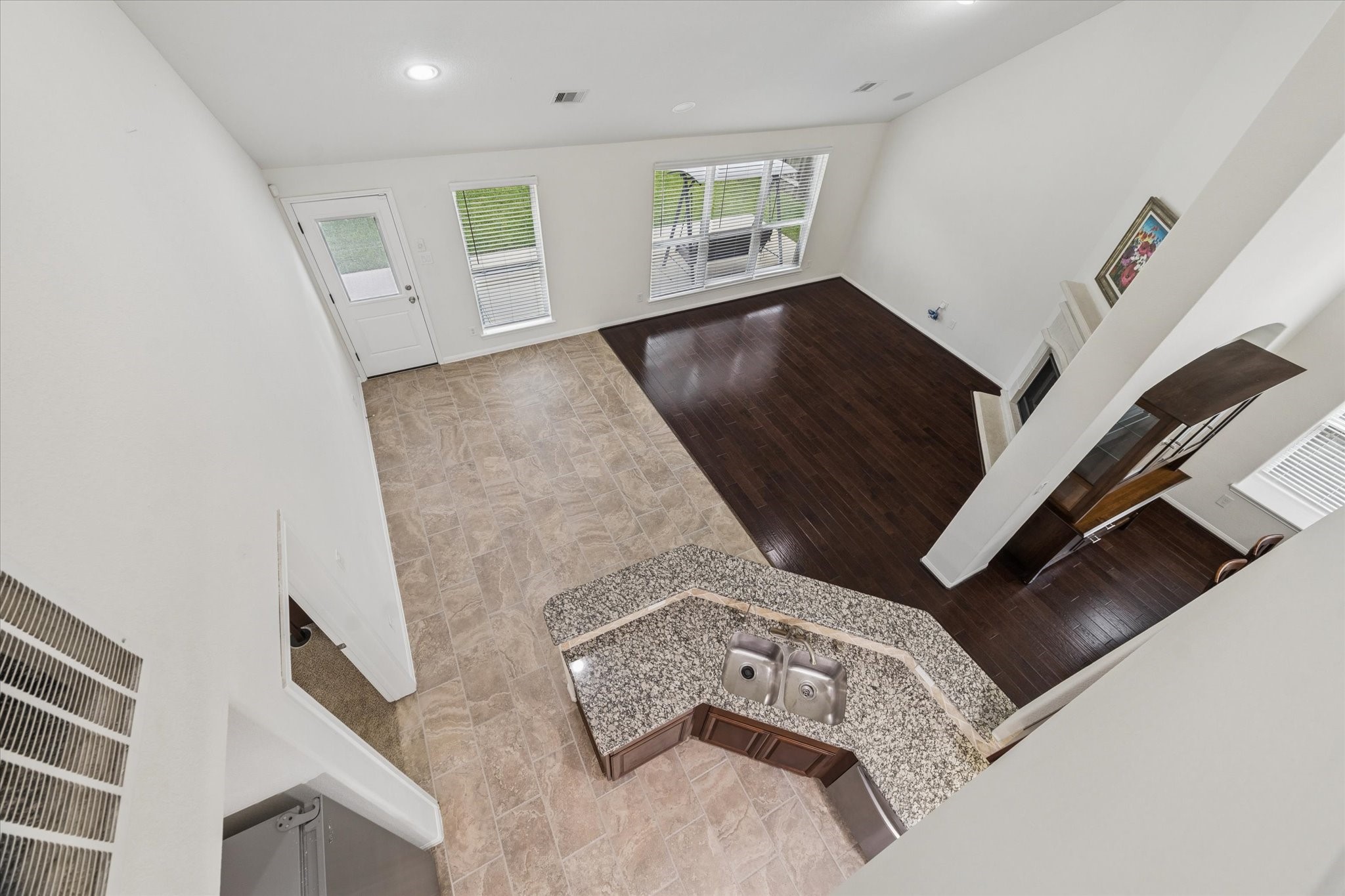 7015 Riata Hills Lane Spring, TX 77379 - Photo 22 of 33 View from the upper level overlooking the kitchen, showcasing the open-concept design that allows for seamless connection and interaction between spaces while cooking and entertaining.