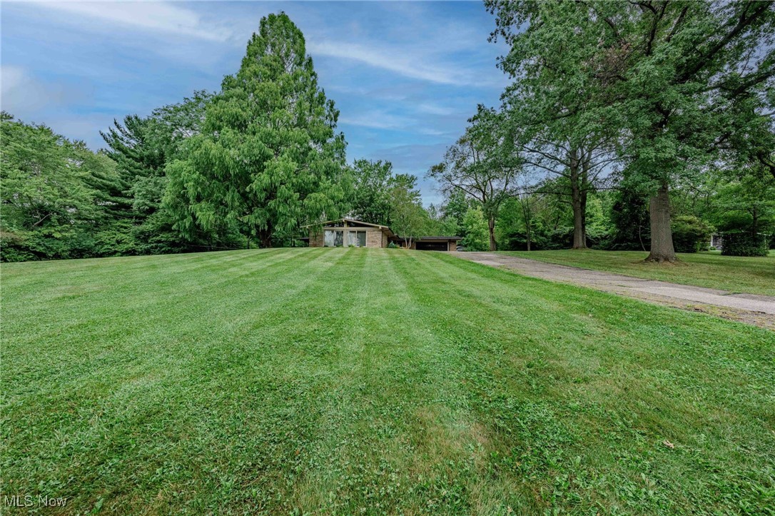 3381 Barrett Road Akron, OH 44333 - Photo 38 of 50 View of green lawn featuring a carport and driveway