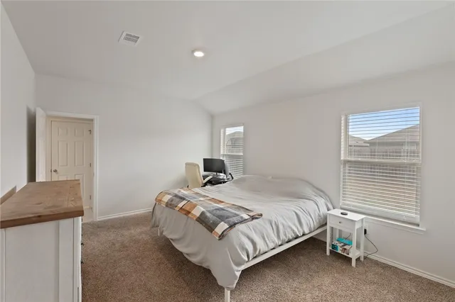 a bathroom with a granite countertop sink and shower