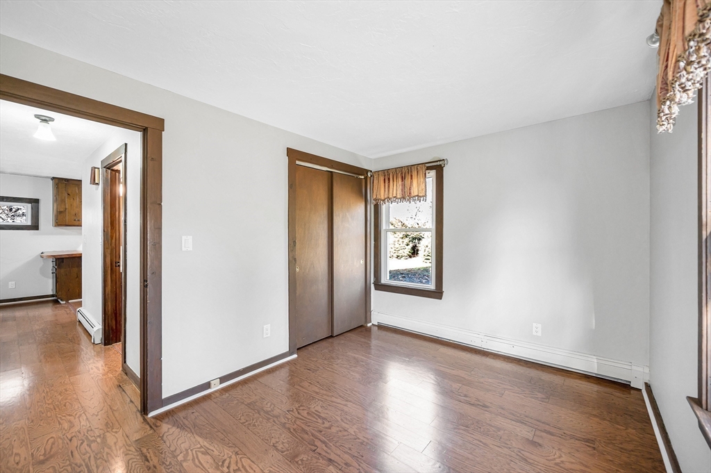 163 Water Street Framingham, MA 01701 - Photo 15 of 37 an empty room with wooden floor and windows