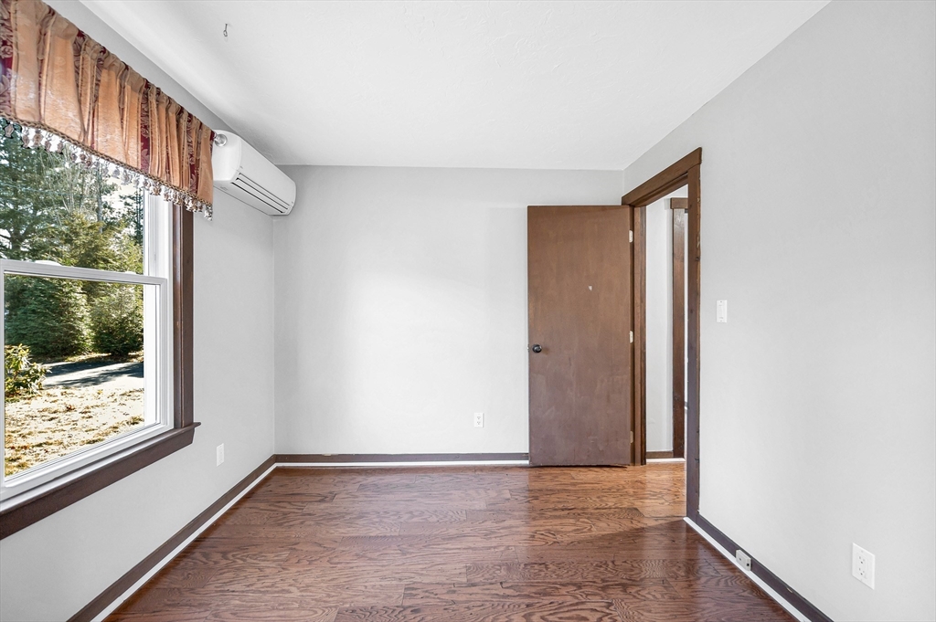 163 Water Street Framingham, MA 01701 - Photo 16 of 37 a view of an empty room with wooden floor and windows