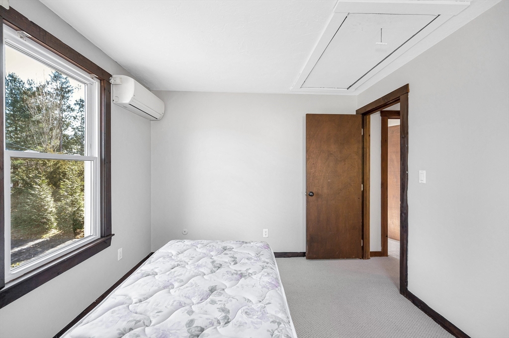 163 Water Street Framingham, MA 01701 - Photo 25 of 37 a view of a big room with wooden floor and a window