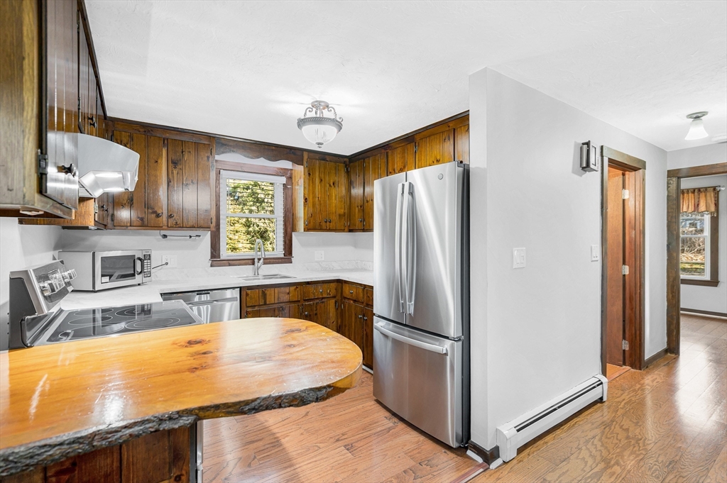 163 Water Street Framingham, MA 01701 - Photo 10 of 37 a kitchen with stainless steel appliances granite countertop a refrigerator and a sink