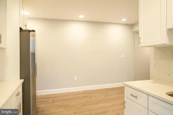a view of a kitchen with wooden floor