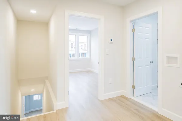 an empty room with windows and entrance