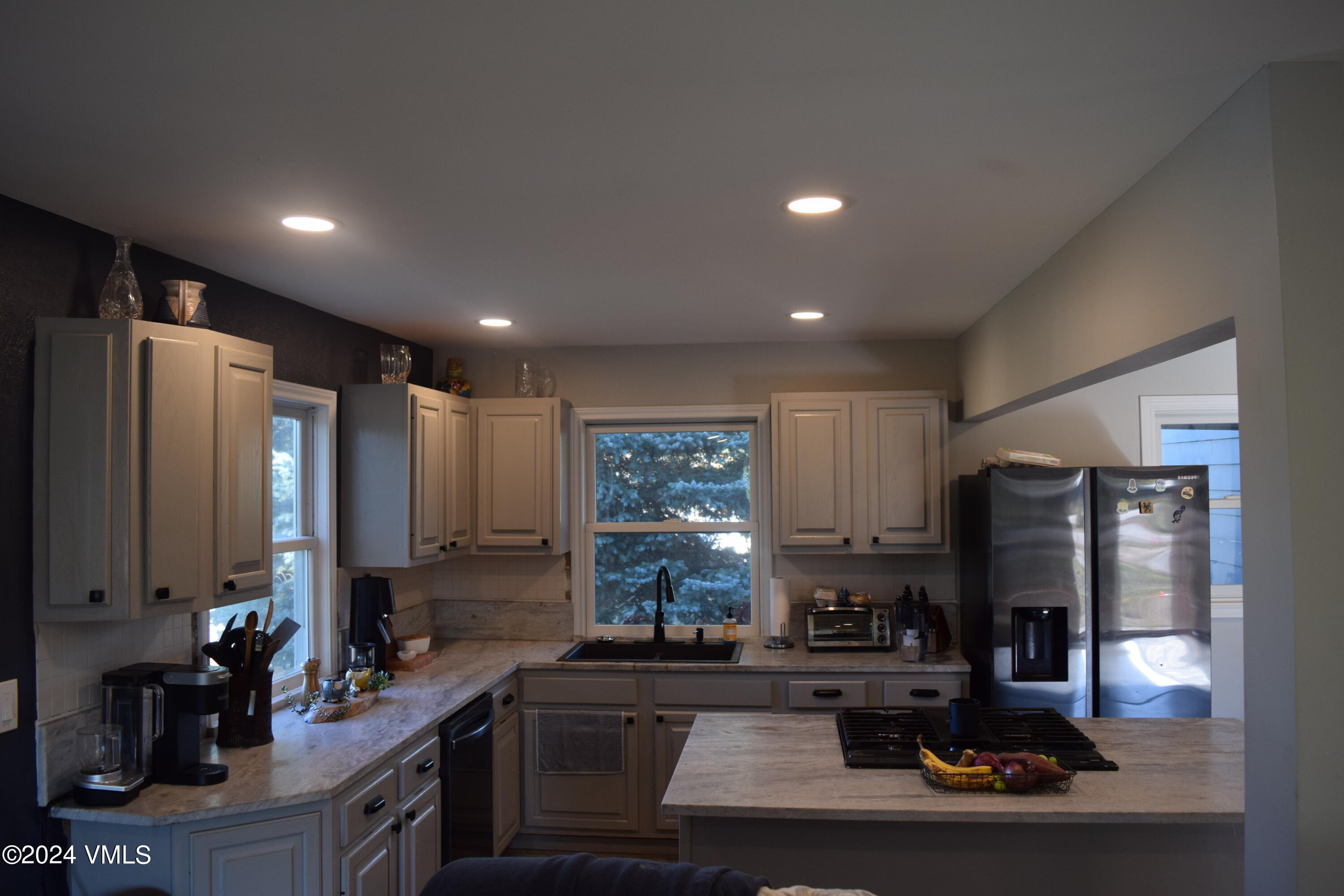 3536 Gypsum Creek Road Gypsum, CO 81637 - Photo 4 of 11 a kitchen with kitchen island granite countertop a sink stove and refrigerator