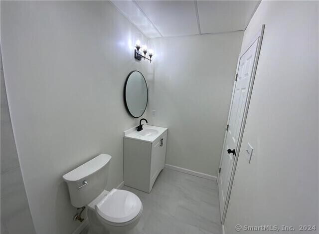 61 Colony Street, Unit 2C Meriden, CT 06451 - Photo 6 of 9 a bathroom with a toilet a sink and mirror