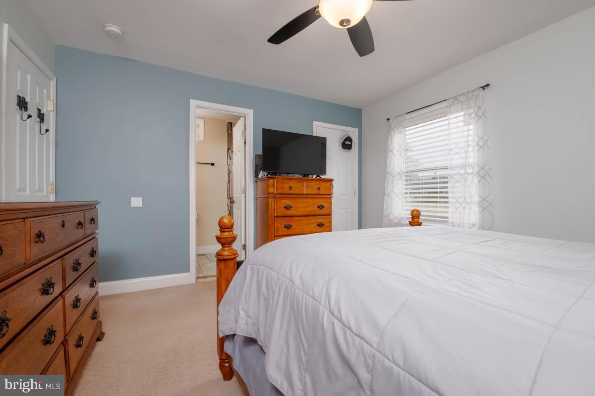 414 Enfield Road Joppa, MD 21085 - Photo 17 of 42 a bedroom with a bed and a chandelier