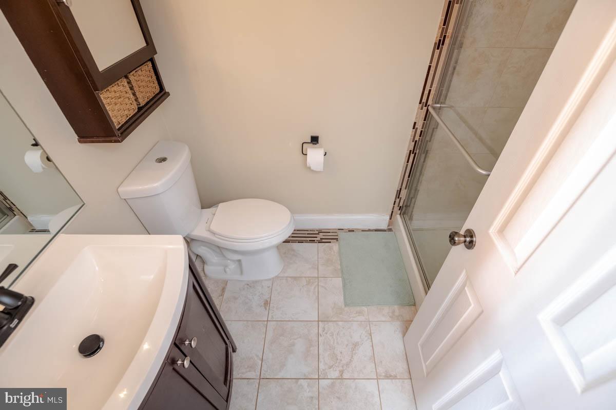 414 Enfield Road Joppa, MD 21085 - Photo 18 of 42 a bathroom with a sink and a mirror