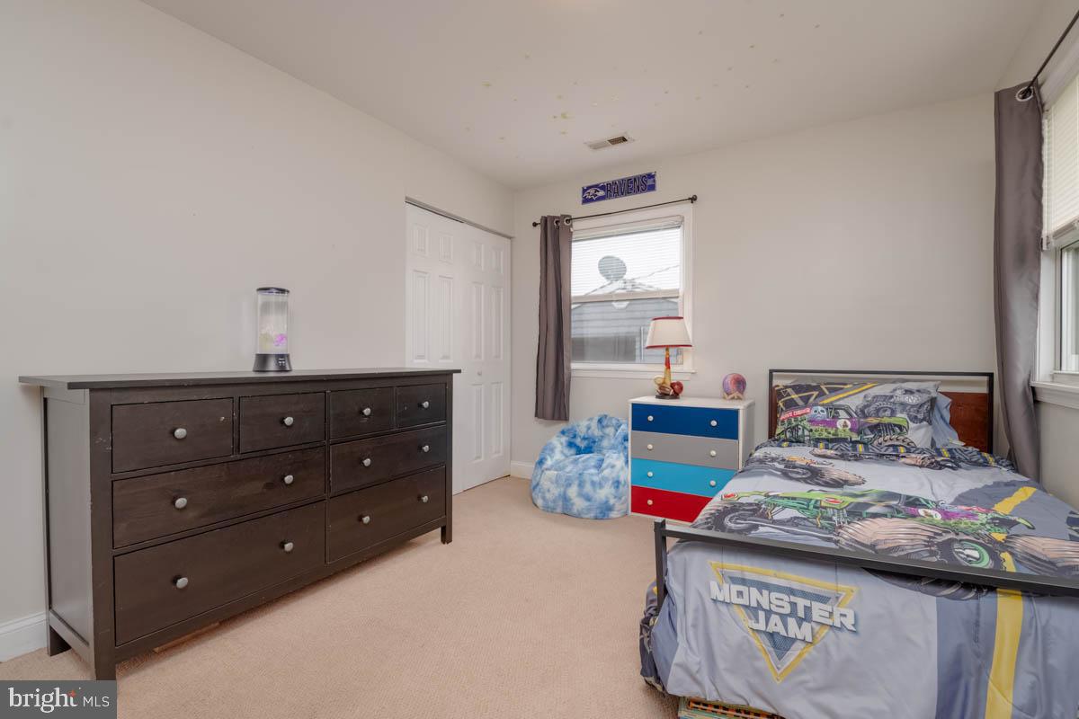 414 Enfield Road Joppa, MD 21085 - Photo 26 of 42 a bedroom with a bed and a dresser in it
