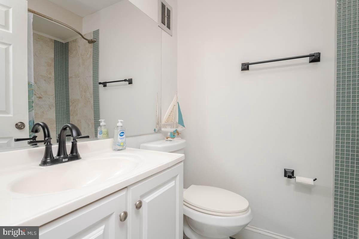 414 Enfield Road Joppa, MD 21085 - Photo 30 of 42 a bathroom with a sink toilet and mirror