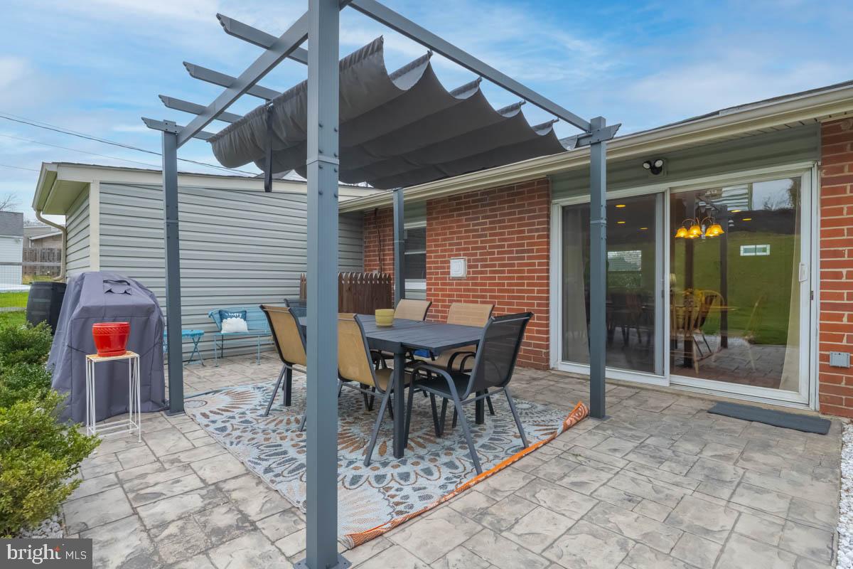 414 Enfield Road Joppa, MD 21085 - Photo 41 of 42 a patio with table and chairs and potted plants
