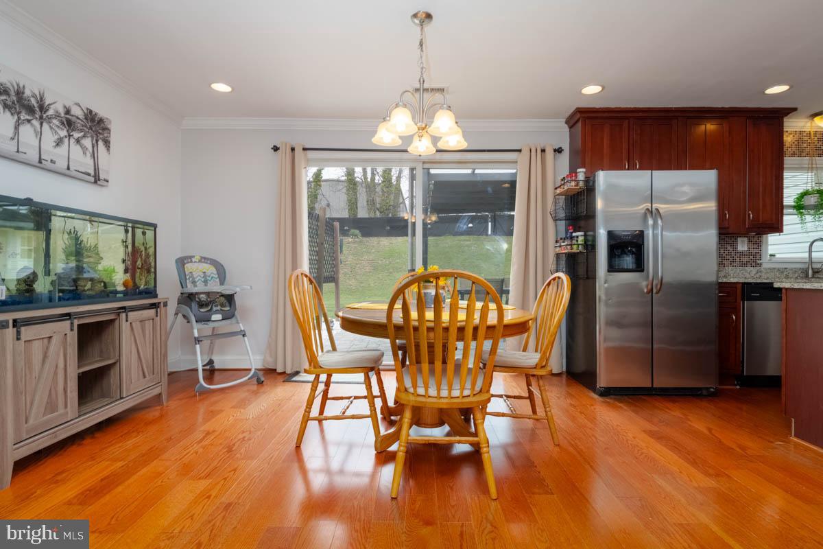 414 Enfield Road Joppa, MD 21085 - Photo 6 of 42 a dining room with furniture a fireplace and wooden floor