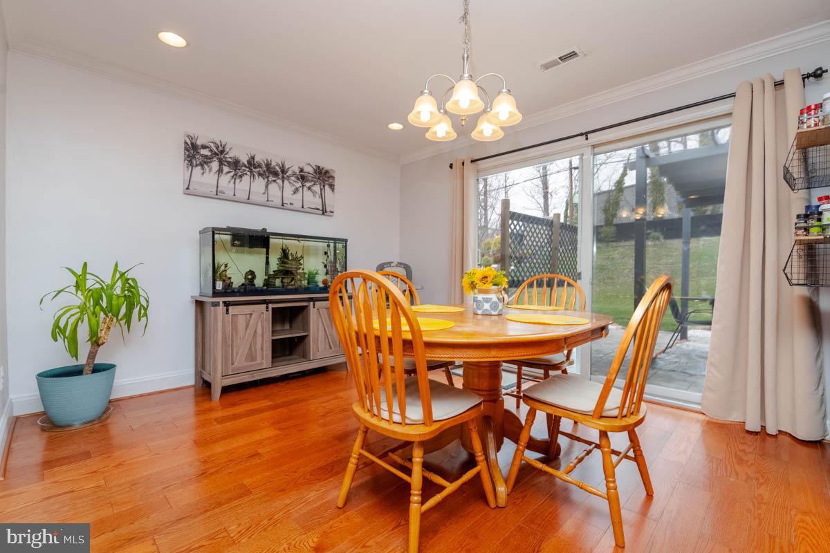 414 Enfield Road Joppa, MD 21085 - Photo 7 of 42 a dining room with furniture potted plants and wooden floor