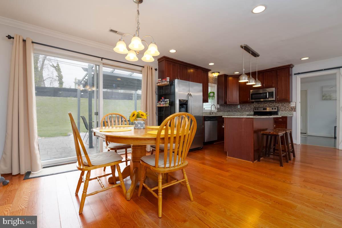 414 Enfield Road Joppa, MD 21085 - Photo 8 of 42 a view of a dining room with furniture window and wooden floor
