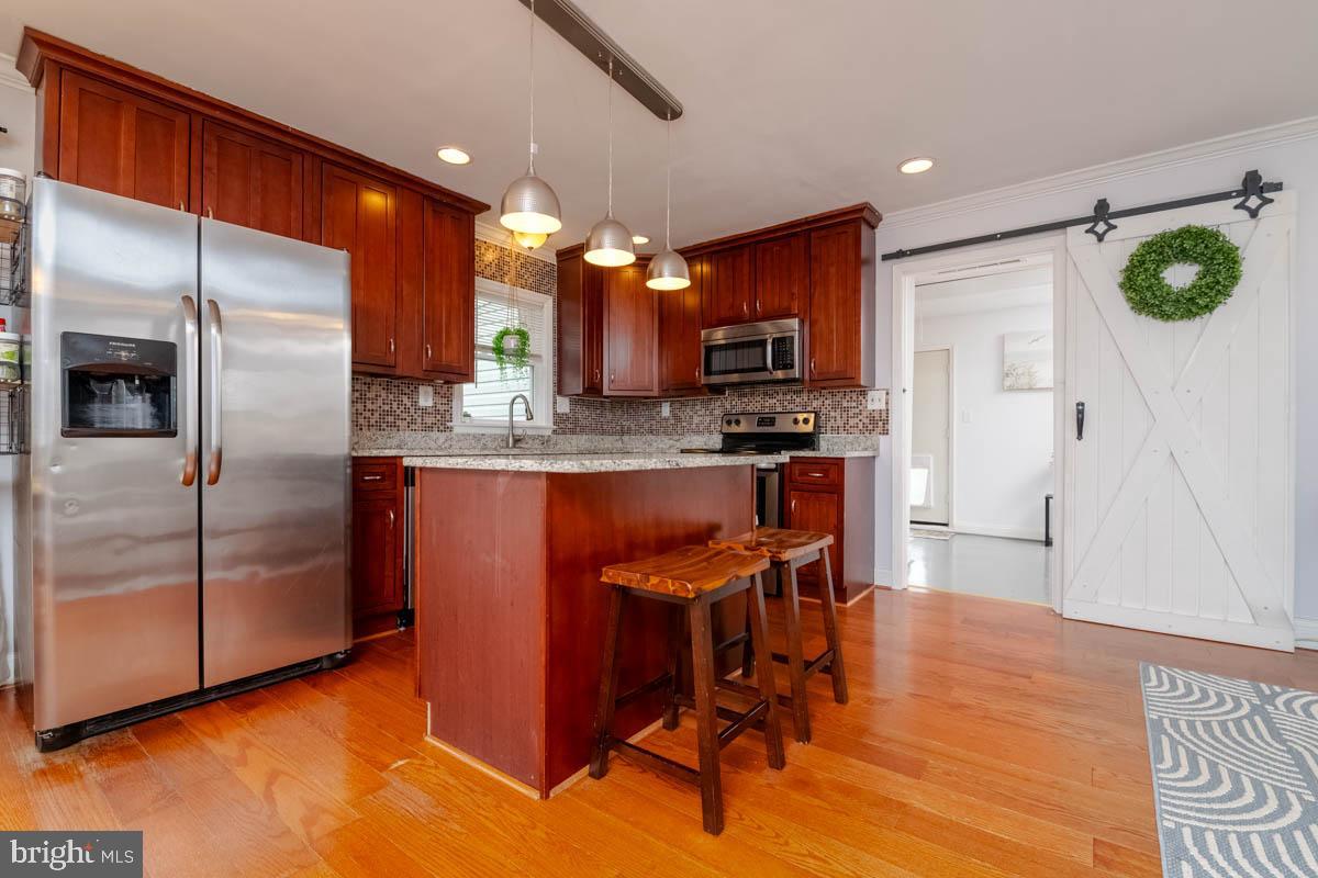 414 Enfield Road Joppa, MD 21085 - Photo 9 of 42 a kitchen with stainless steel appliances granite countertop a refrigerator a stove top oven a sink and dishwasher