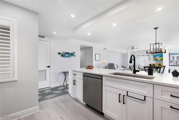 a kitchen with a sink stainless steel appliances and cabinets