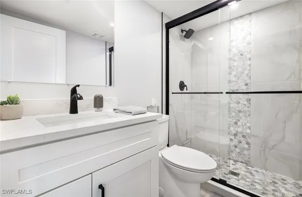 a bathroom with a sink toilet and shower
