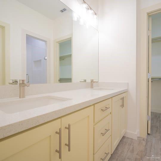 3052 Briggs Road, Unit C Weslaco, TX 78596 - Photo 12 of 16 Double vanity featuring white integrated sinks, light-toned countertops, and brushed nickel faucets