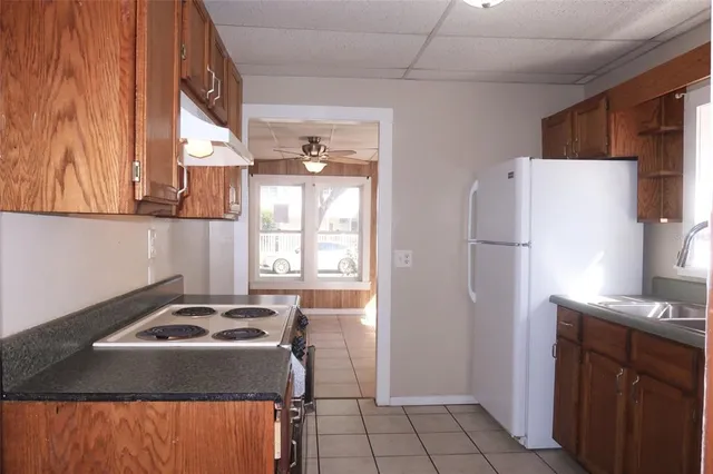 a kitchen with a refrigerator and a sink