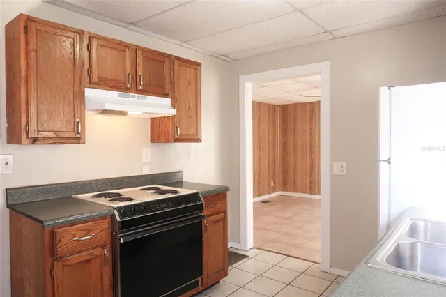 a stove top oven sitting inside of a kitchen