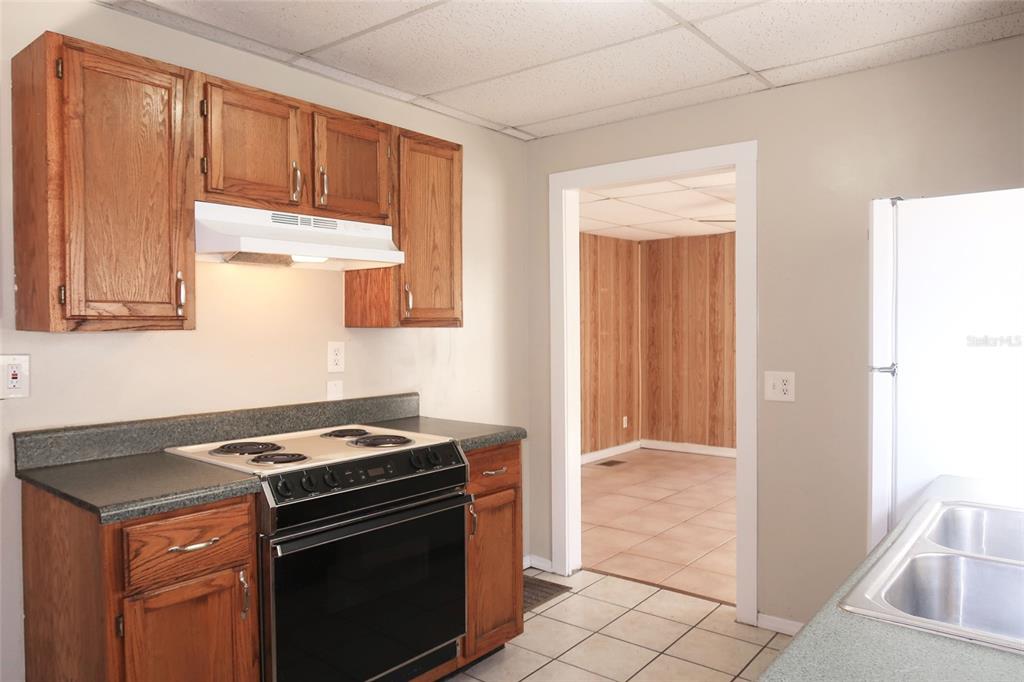 5353 10th Street Zephyrhills, FL 33542 - Photo 17 of 26 a stove top oven sitting inside of a kitchen