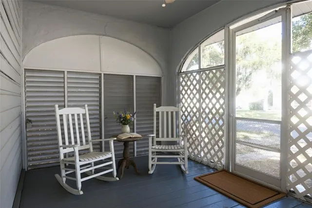 a view of front door with chair and table