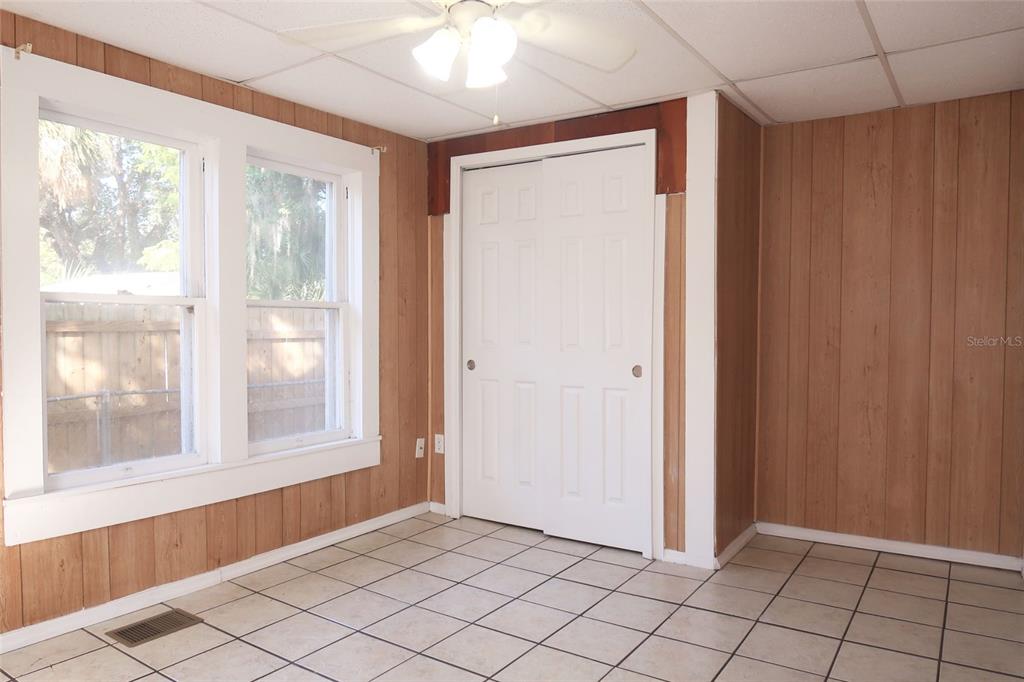 5353 10th Street Zephyrhills, FL 33542 - Photo 23 of 26 a view of an empty room with window and chandelier fan