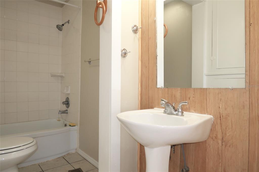 5353 10th Street Zephyrhills, FL 33542 - Photo 24 of 26 a bathroom with a sink a toilet and shower