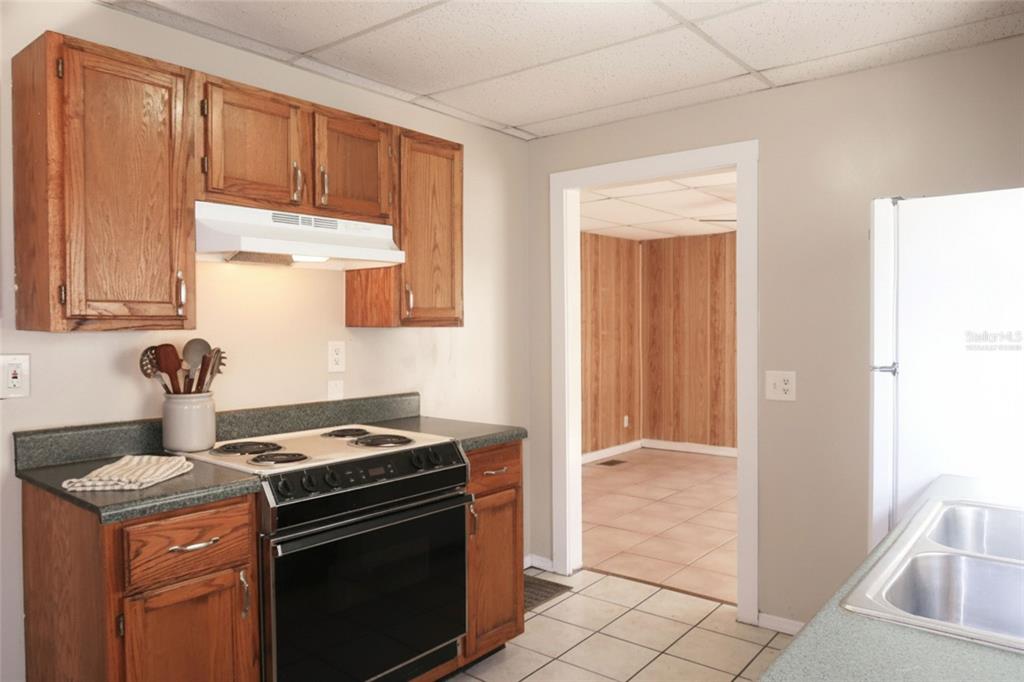 5353 10th Street Zephyrhills, FL 33542 - Photo 4 of 26 a kitchen with a stove and a microwave