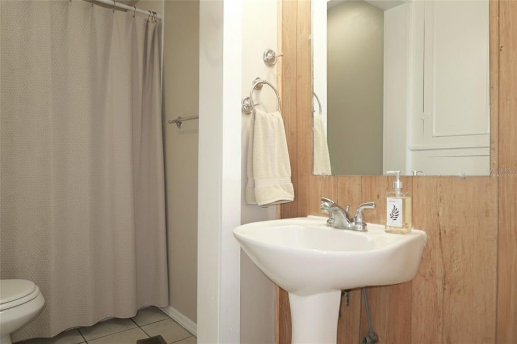 5353 10th Street Zephyrhills, FL 33542 - Photo 7 of 26 a bathroom with a sink and a mirror