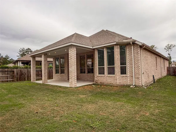 a view of a house with a yard and a large window