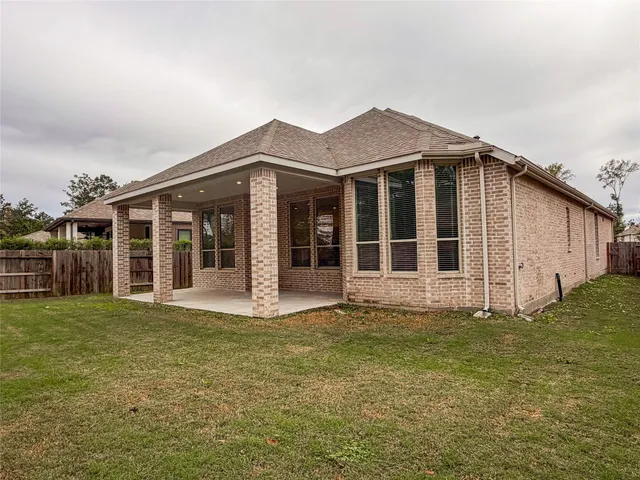 a view of a house with a yard and a large window