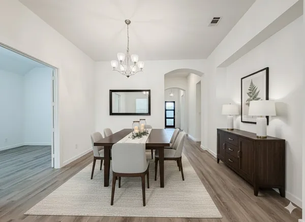 a view of a dining room with furniture and wooden floor